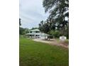 Spacious home with an attached garage, a large front yard, and mature trees at 10245 Sw 105Th St, Ocala, FL 34481