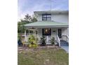 Charming home featuring a welcoming covered front porch and well-maintained landscaping at 10245 Sw 105Th St, Ocala, FL 34481