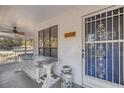 Front porch with a white swing and blue door at 10245 Sw 105Th St, Ocala, FL 34481