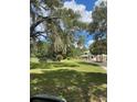 Spacious front yard featuring mature trees and a charming two-story home at 10245 Sw 105Th St, Ocala, FL 34481