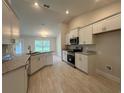 Bright kitchen featuring white cabinets, stainless steel appliances, and granite countertops at 10927 Sw 41St Ave, Ocala, FL 34476