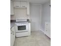 Simple kitchen with white cabinets and a stove at 10973 Sw 86Th Ct, Ocala, FL 34481