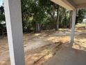 View from the covered patio of the home's backyard with a wood fence surround at 13 Nw 45Th Loop, Ocala, FL 34475