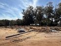 Cleared lot ready for new construction with sandy soil and some trees at 13 Nw 45Th Loop, Ocala, FL 34475