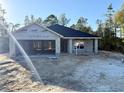 New construction home, block exterior walls, and a dark-colored roof at 15128 Se 93Rd Ave, Summerfield, FL 34491