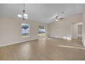 Bright and spacious living room with laminate floors and ceiling fan at 16360 Se 88Th Ct, Summerfield, FL 34491