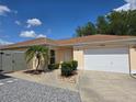 Charming single-story home with a well-manicured lawn and a two-car garage at 1801 Marquez Loop, Lady Lake, FL 32159