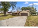 Exterior view of house with driveway and landscaping at 2540 Se 35Th St, Ocala, FL 34471