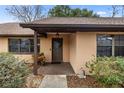 House entrance with a dark brown door and landscaping at 2540 Se 35Th St, Ocala, FL 34471