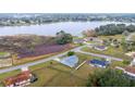 Aerial view of a single story home, fenced yard, and partial lake view at 331 Oak Lane Dr, Ocala, FL 34472