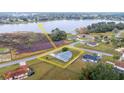 Aerial view of a charming home with lake access and a fenced yard offering serene waterfront living at 331 Oak Lane Dr, Ocala, FL 34472