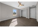 Bright bedroom with wood-look floors, large closet, and a window at 3444 Se 139 Ln, Summerfield, FL 34491