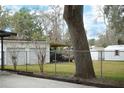 Spacious backyard with detached garage, shed, and mature trees at 404 Cr 487, Lake Panasoffkee, FL 33538