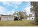 Two-car garage with covered carport and ample space at 404 Cr 487, Lake Panasoffkee, FL 33538