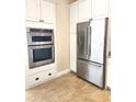 Kitchen features stainless steel appliances and white cabinetry at 4117 Sw 30Th Ct, Ocala, FL 34474