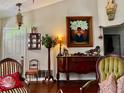 Living room boasts hardwood floors and antique furniture, creating a warm atmosphere at 4360 Se 62Nd St, Ocala, FL 34480