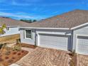 New home exterior featuring a two-car garage and landscaped walkway at 5365 Nw 46Th Lane Rd, Ocala, FL 34482