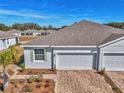 New home exterior with a two-car garage and a brick paver driveway at 5365 Nw 46Th Lane Rd, Ocala, FL 34482