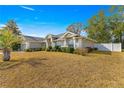 Side view of a single-story house with a fenced backyard at 8120 Sw 56Th Ter, Ocala, FL 34476