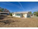 Home's backyard view, featuring a screened patio and fenced yard at 8274 Sw 106Th Pl, Ocala, FL 34481