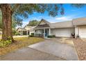 Villa with driveway, mature tree, and neatly landscaped yard at 8785 Sw 91St St # B, Ocala, FL 34481