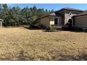 House exterior featuring a large grassy front yard and a stone accented front porch at 9143 Sw 70Th Loop, Ocala, FL 34481