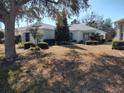 House exterior showcasing landscaping and a paved walkway at 9686 Sw 92Nd Place Rd, Ocala, FL 34481