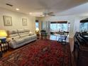 Bright living room featuring hardwood floors, ceiling fan, and traditional furnishings at 9686 Sw 92Nd Place Rd, Ocala, FL 34481