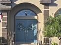 Inviting double front doors with decorative wreaths and arched entryway at 10870 Sw 47Th Ct, Ocala, FL 34476