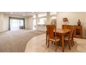 Bright dining room with wooden table and chairs, open to kitchen at 16205 Sw 12Th Ter, Ocala, FL 34473