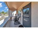 Private balcony with rocking chairs overlooking the community at 2418 Ne 7Th St # 10, Ocala, FL 34470