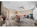 Living room with gray sofas, wood-look floors, and a ceiling fan at 2701 Sw 175Th Loop, Ocala, FL 34473