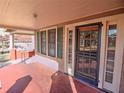 Front porch with red tile floor and a screened door at 309 Ne Sanchez Ave, Ocala, FL 34470