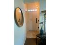 Bright entryway with a mirror, coat closet and tiled floor at 3396 Parkchester Square Blvd # 103, Orlando, FL 32835