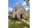 Two-story tan house with a covered porch and landscaping at 3396 Parkchester Square Blvd # 103, Orlando, FL 32835