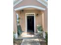 Inviting front porch with two green chairs and a welcome mat at 3396 Parkchester Square Blvd # 103, Orlando, FL 32835