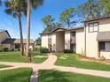 Condo building exterior showcasing a walkway and landscaping at 623 Midway Dr # B, Ocala, FL 34472