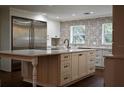 Bright kitchen with white cabinets, large island, and stainless steel appliances at 6255 Mercantile Ln, Fort Meade, FL 33841