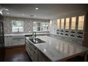 Spacious kitchen featuring a large island, white cabinets, and modern appliances at 6255 Mercantile Ln, Fort Meade, FL 33841