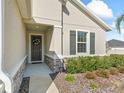 Front entrance with stone accents and landscaping at 6267 Se 13Th St, Ocala, FL 34472