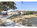 Single-story house with a two-car garage and a well-maintained lawn at 6767 Sw 91St Cir, Ocala, FL 34481