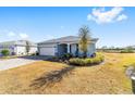 One-story home with light gray siding, paver driveway, and landscaped yard at 7865 Sw 89Th Cir, Ocala, FL 34481