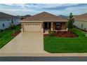 A cozy single-story home with a well-manicured front yard, a two-car garage, and landscaping at 8902 Sw 75Th Loop, Ocala, FL 34481