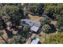 An aerial view of home with a fenced yard, outbuildings, and mature trees at 9352 Ne 27Th Ter, Anthony, FL 32617