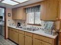 Kitchen with wood cabinets, double sink, and appliances at 11256 Sw 78Th Ave, Ocala, FL 34476