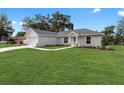 Newly built home with a spacious front yard and driveway at 1302 Ne 22Nd Ave, Ocala, FL 34470