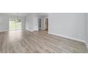 Open living area with vinyl plank flooring, and access to backyard at 15482 Sw 10 Pl, Ocala, FL 34481