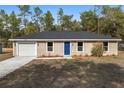 Cozy single-Gathering home featuring a one-car garage and freshly landscaped front at 15982 Sw 30 Ln, Ocala, FL 34481