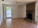 Bright living room with stone fireplace and large window at 1804 Sw 29Th Ter, Ocala, FL 34474