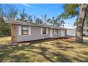 View of the renovated house with a new driveway and added mulch at 26 Spring Cir, Ocala, FL 34472